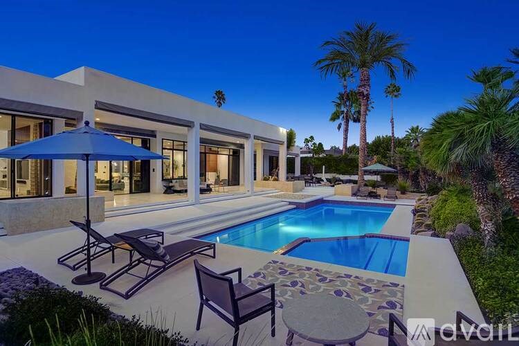 A modern house with a pool in the backyard.