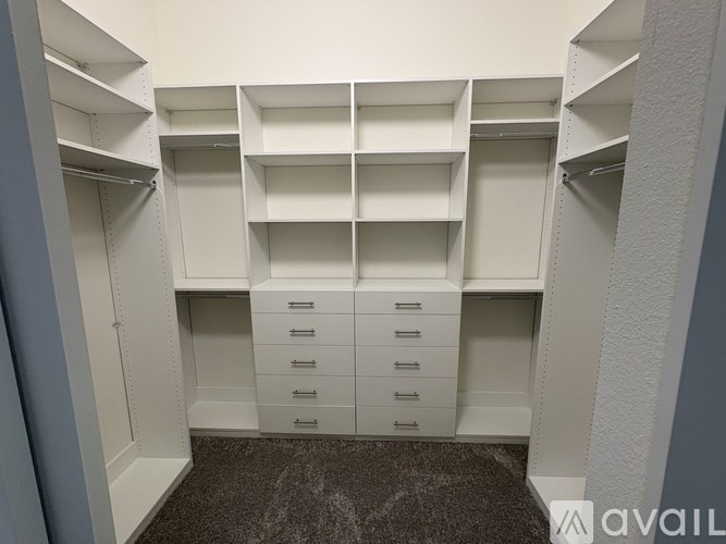 A white storage unit with shelves and drawers.