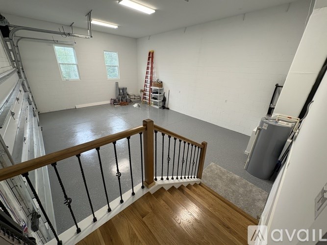 A room with a wooden staircase and a ladder.