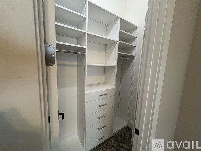 A white closet with shelves and drawers is shown.