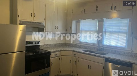 A kitchen with a stainless steel refrigerator, stove, and cabinets.