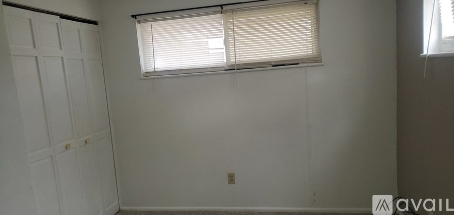 A white room with a window and a door.