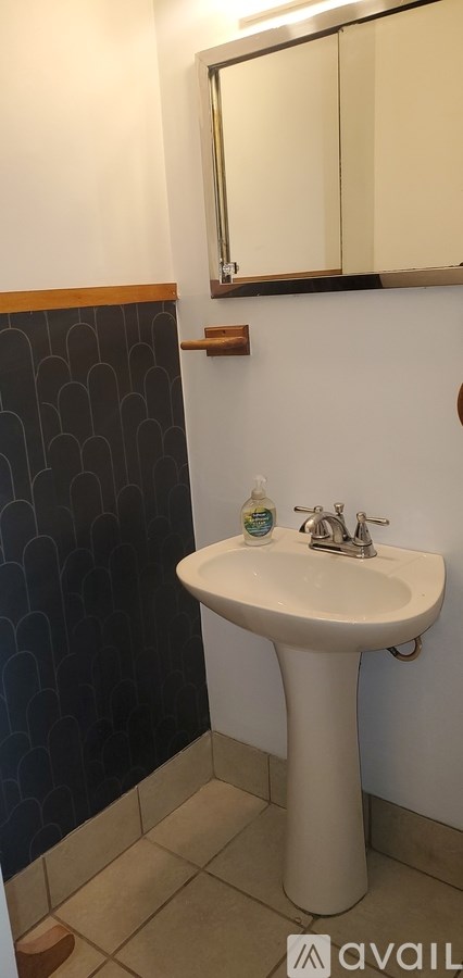 A bathroom with a sink and mirror.