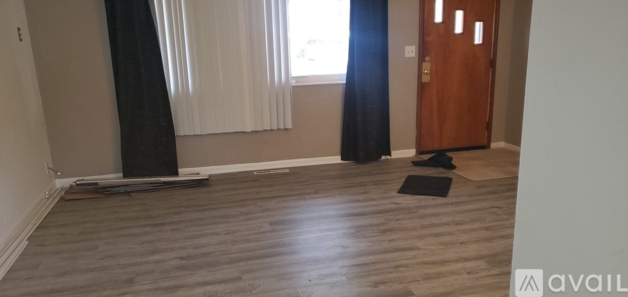 A room with wooden floors and a door.