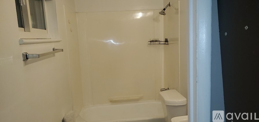 A bathroom with a toilet, sink, and bathtub.