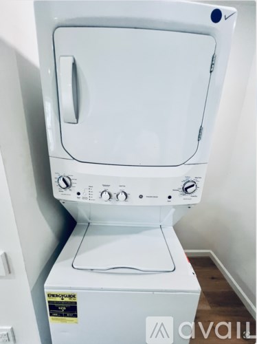 A white dryer is sitting in a room.