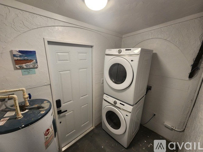 A laundry room with a washer and dryer stacked on top of each other.
