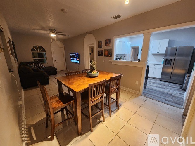 A dining room with a wooden table and chairs.