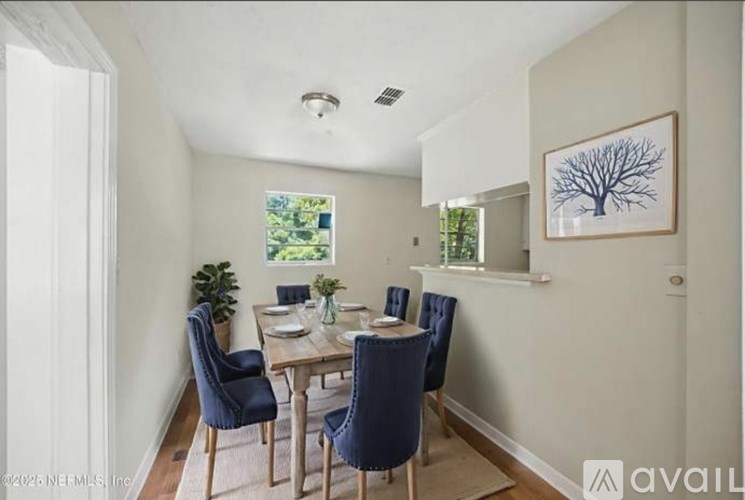 A dining room with a table set for four.