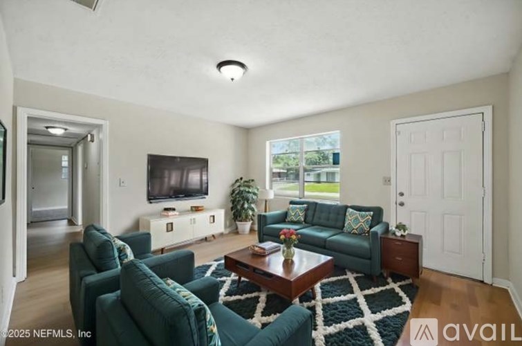 A living room with a green couch and a coffee table.