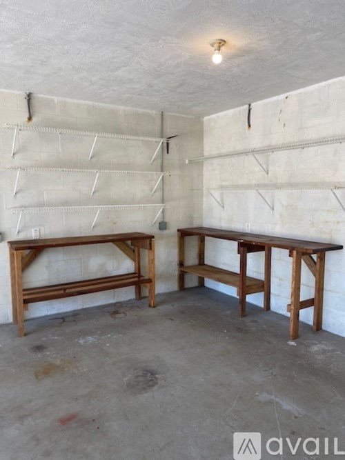 A room with a wooden bench and a wall under construction.