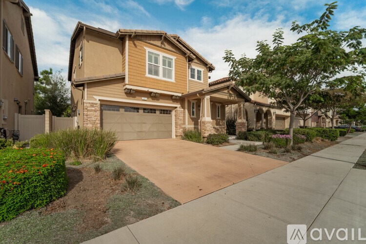 A house with a brown garage door is for sale.
