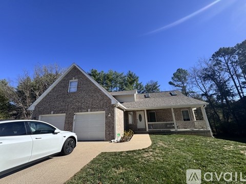 A house with a car parked in front of it.
