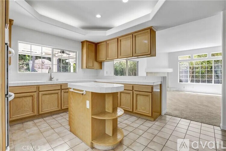 A kitchen with wooden cabinets and a white countertop.