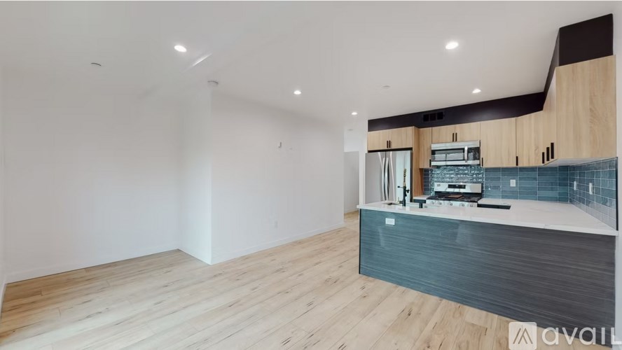 A kitchen area with wooden floors and a modern design.