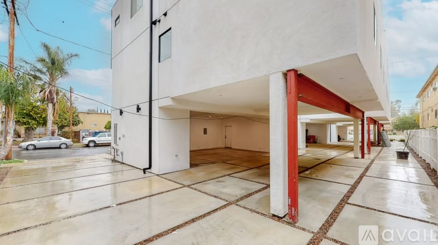 A modern house with a white exterior and a red pillar is for sale.