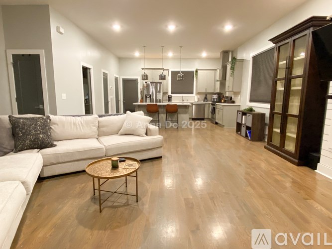 A modern living room with a white sofa and a wooden coffee table.