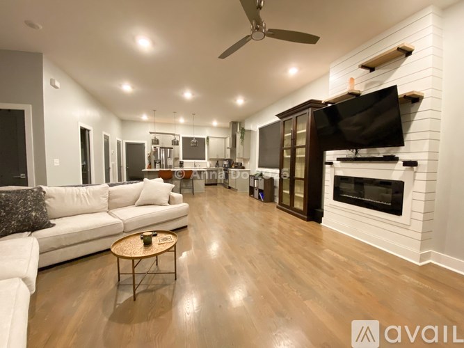 A modern living room with a fireplace and a television.