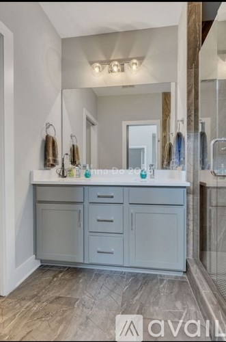 A bathroom vanity with a mirror above it.