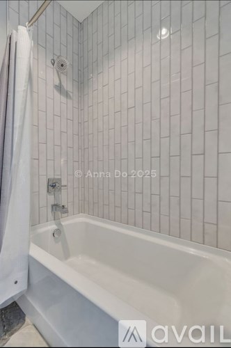 A white bathtub in a bathroom with a shower curtain.