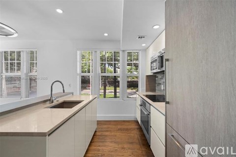 A modern kitchen with a sink and a window.