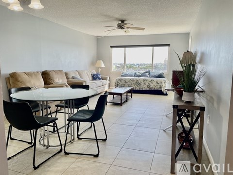 A living room with a dining table and chairs.