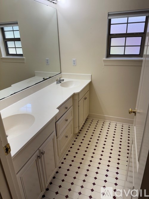 A bathroom with a white sink and a tiled floor.