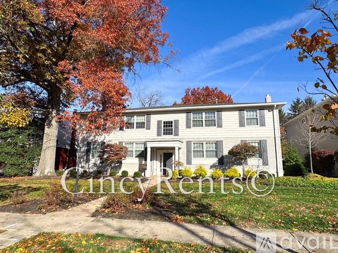 A house with a tree in front of it.