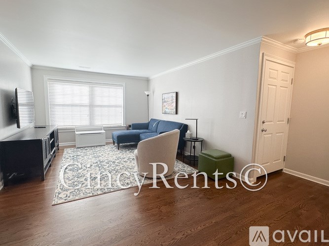 A living room with a blue chair and a white couch.