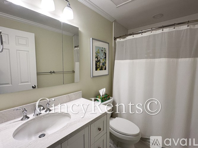 A bathroom with a white sink and toilet.
