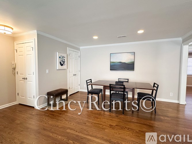 A dining room with a table set for four.