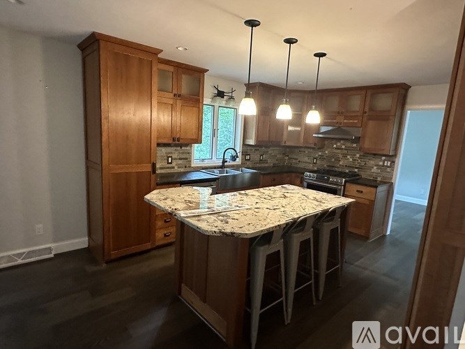 A kitchen with wooden cabinets and a granite countertop.