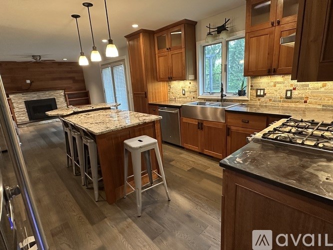 A kitchen with wooden cabinets and a granite countertop.