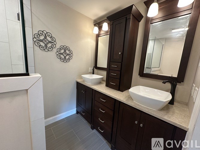 A bathroom with a white sink and a mirror.
