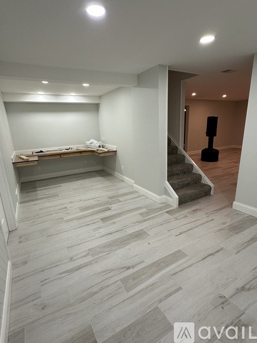 A room with a staircase and a speaker in the corner.