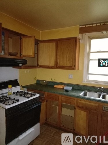 A kitchen with a stove and sink.