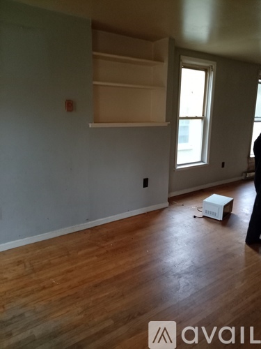A room with wooden floors and a window.