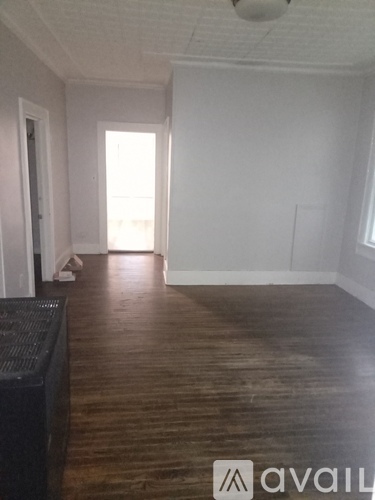 A room with wooden floors and white walls.
