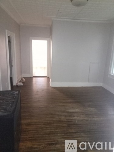 A room with wooden floors and white walls.