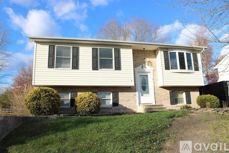 A house with a white front and a white door is for sale.