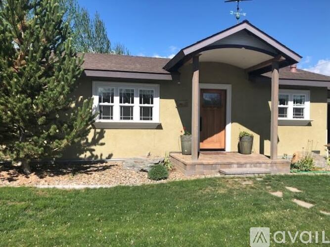 A house with a brown roof and a front porch.