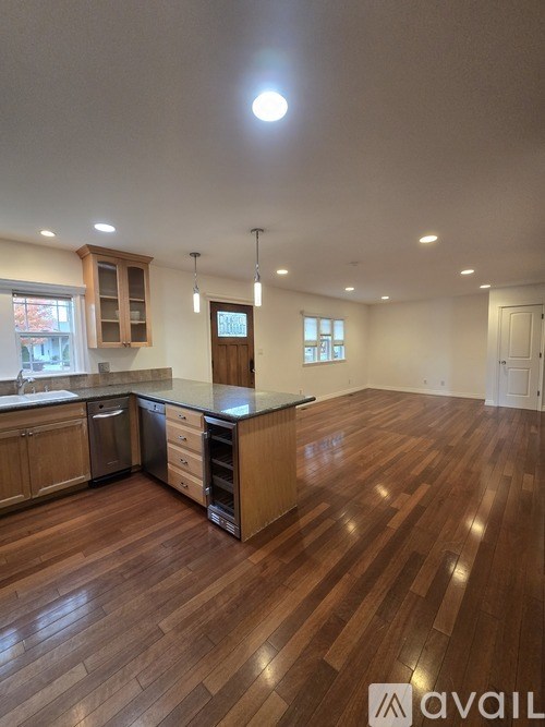 A kitchen with wooden floors and a countertop.
