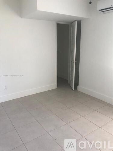 A room with a door and a tiled floor.