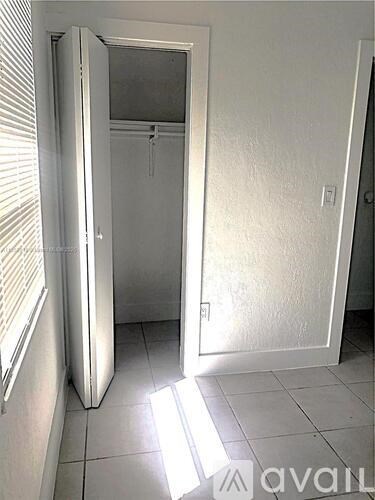 A white bathroom with a toilet and a sink.