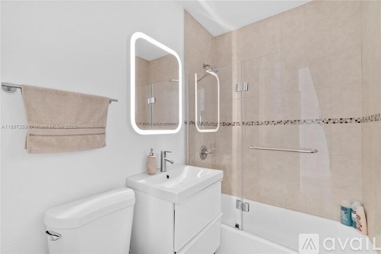 A bathroom with a white sink and toilet.