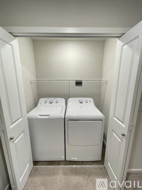 A small laundry room with a washer and dryer.