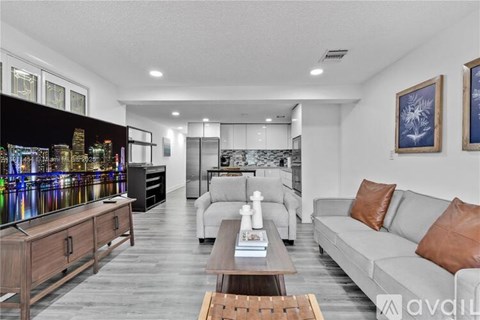 A modern living room with a grey sofa and a wooden coffee table.