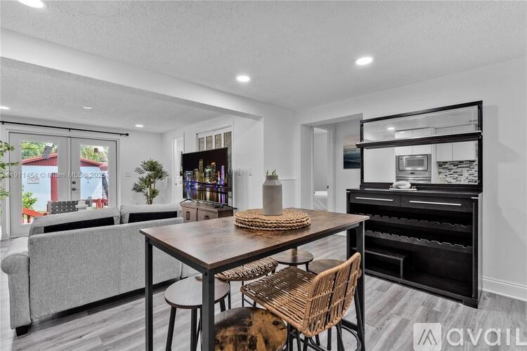 A modern dining room with a wooden table and chairs.