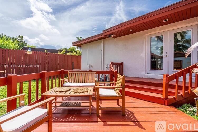 A wooden deck with a table and chairs is available for rent.