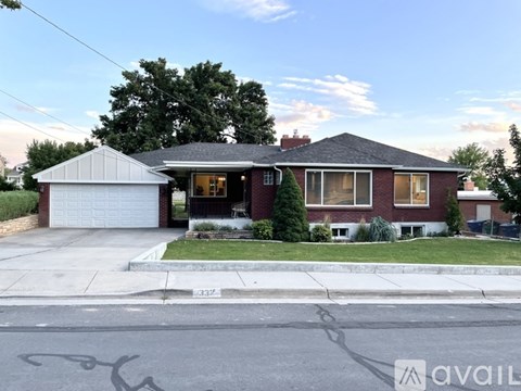A house with a garage and a driveway in front of it.